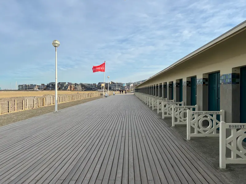 Les Planches wooden boardwalk lined with beach cabins along Deauville beach