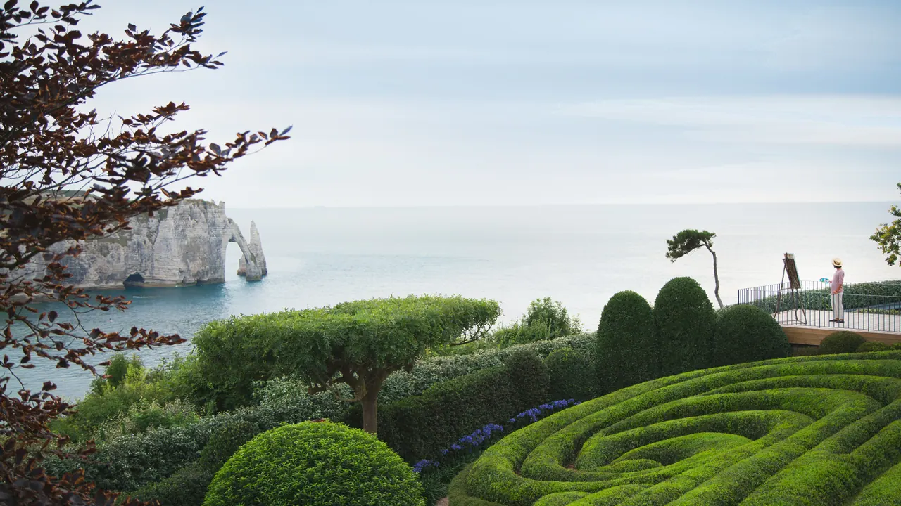 Clipped topiary waves in the Jardins d'Étretat overlooking the sea and cliffs