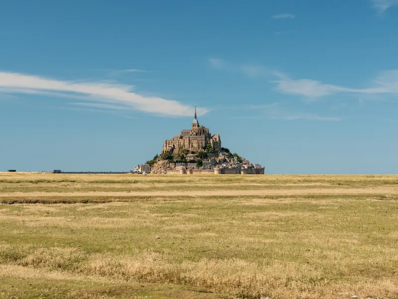 Mont-Saint-Michel on the horizon beyond salt meadows on a clear day