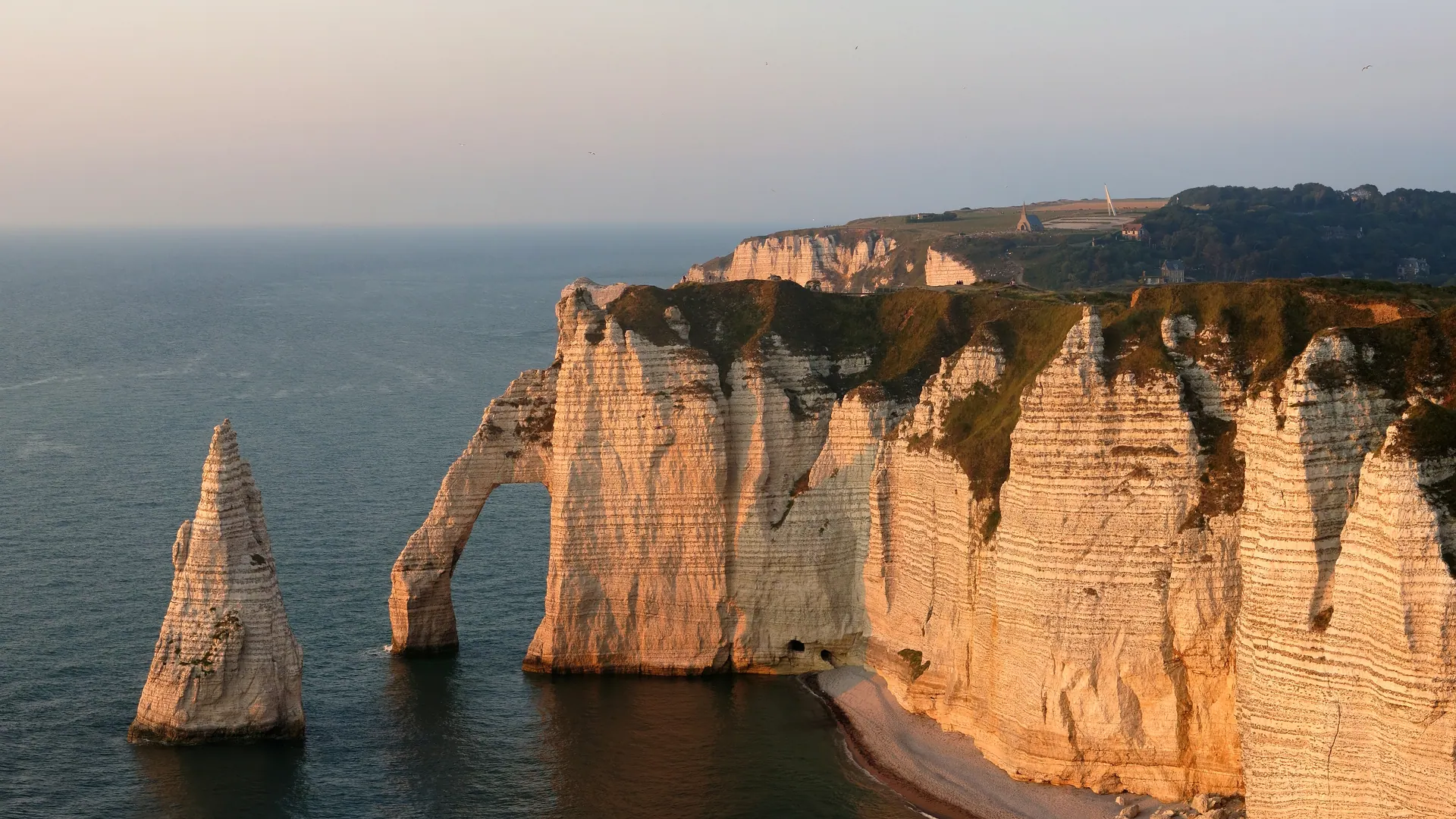 Étretat cliffs, Porte d'Aval arch and Aiguille in warm evening light