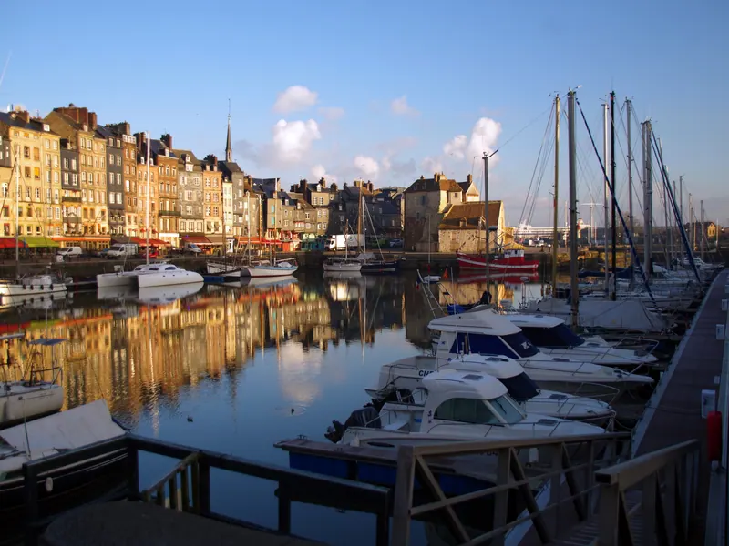 Morning light on the Vieux Bassin harbour in Honfleur, with boats and quayside houses