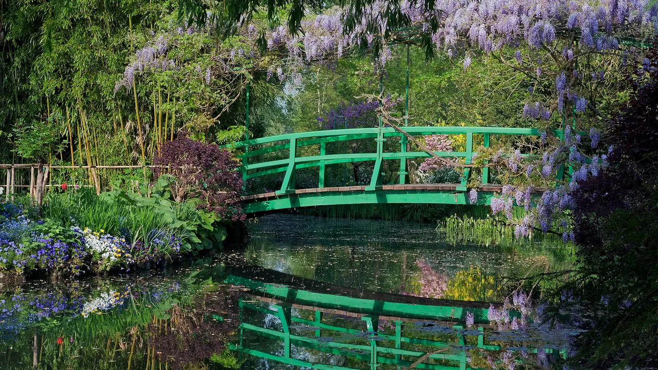 Monet's Japanese bridge covered in wisteria above the water-lily pond at Giverny