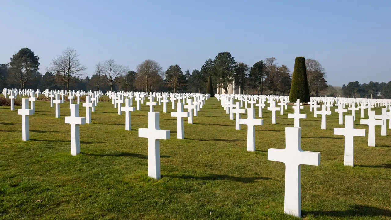 Rows of white marble crosses on the lawn of the Normandy American Cemetery