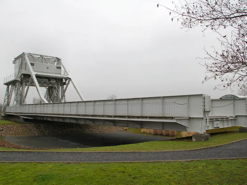 Side view of the original Pegasus Bridge resting on the lawn at Ranville